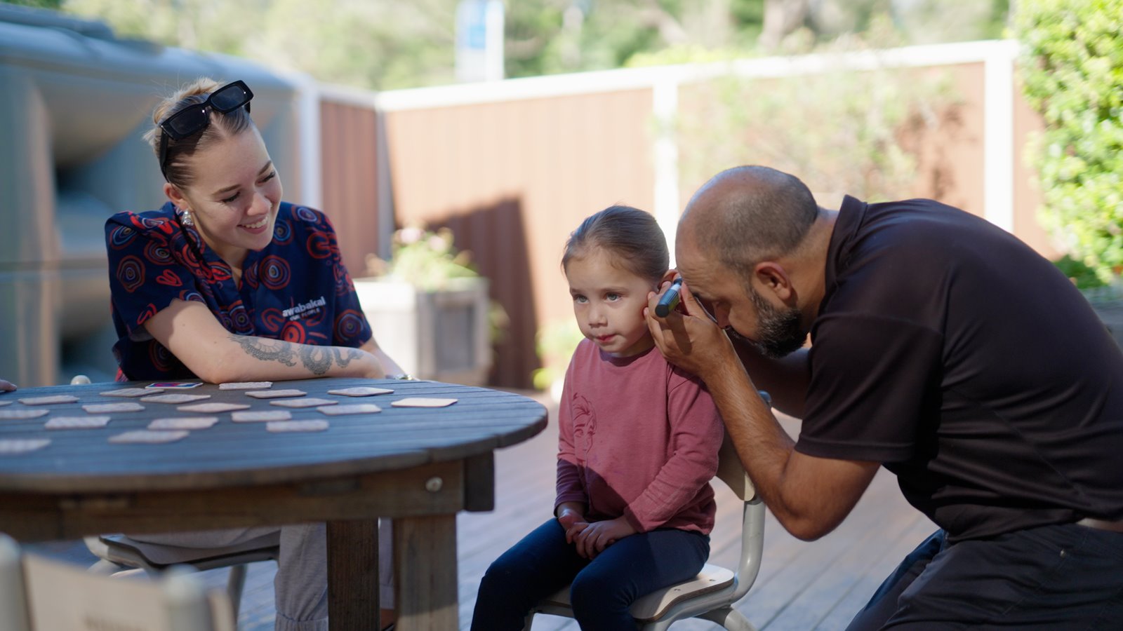 Hearing Australia First Nations team conducting a hearing check for a child in a caring environment
