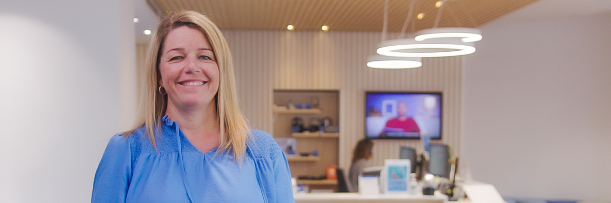 A friendly staff member smiling warmly at the Hearing Australia centre