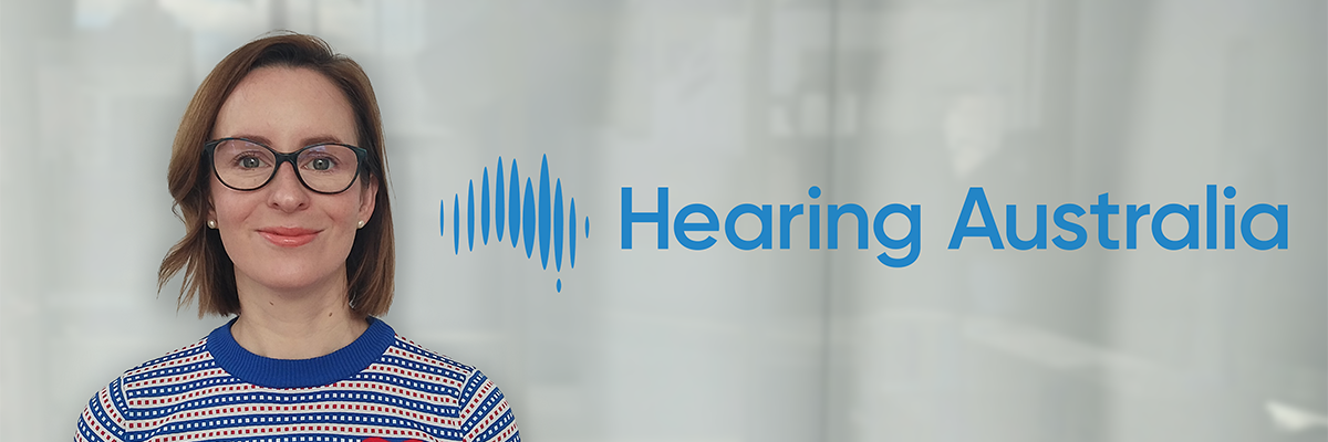 Ebonie, Customer Service Officer at Hearing Australia, smiling warmly and friendly next to Hearing Australia logo