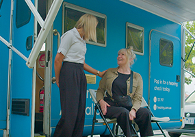 Hearing Australia Community Hearing Advisor smiling warmly while interacting with clients