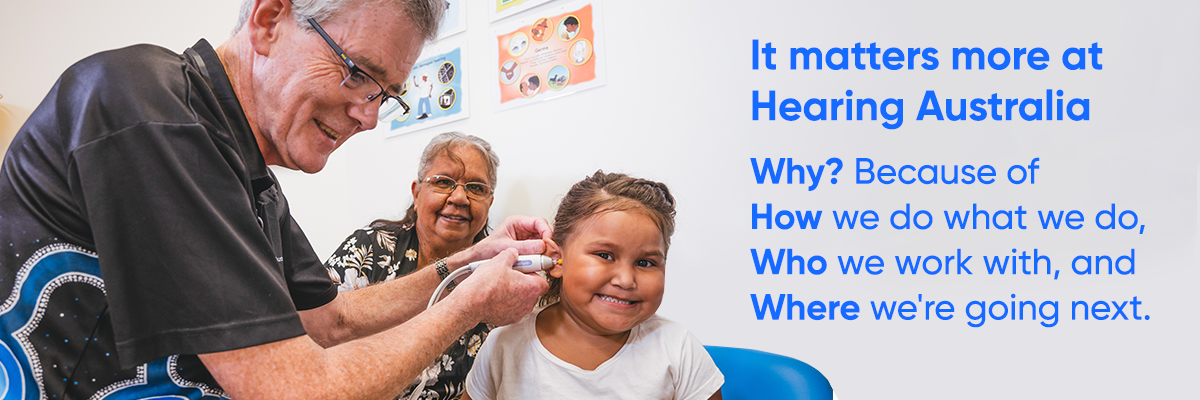 A Hearing Australia audiologist conducting a hearing check for First Nations children, with his family nearby
