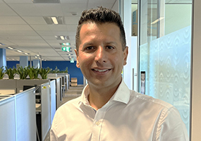 Head of Applications, San Deep, smiling confidently at Hearing Australia