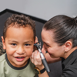 Hearing Australia audiologist conducting a hearing test with a young child patient in a friendly clinical setting