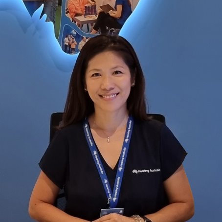 Irene, a customer service officer, smiling warmly at a Hearing Australia centre