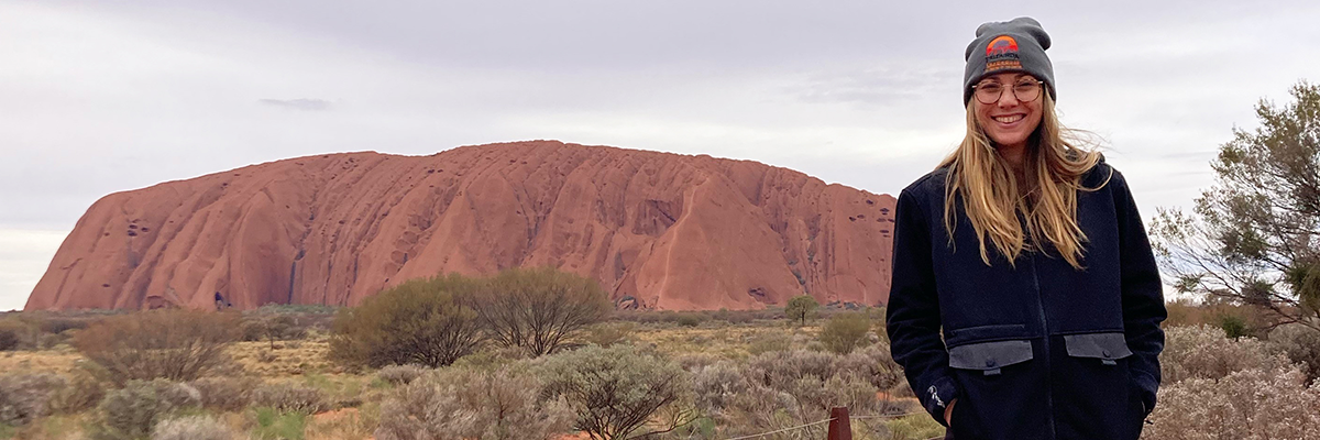 Hearing Australia paediatric audiologist Madeleine smiling warmly and friendly at Uluru