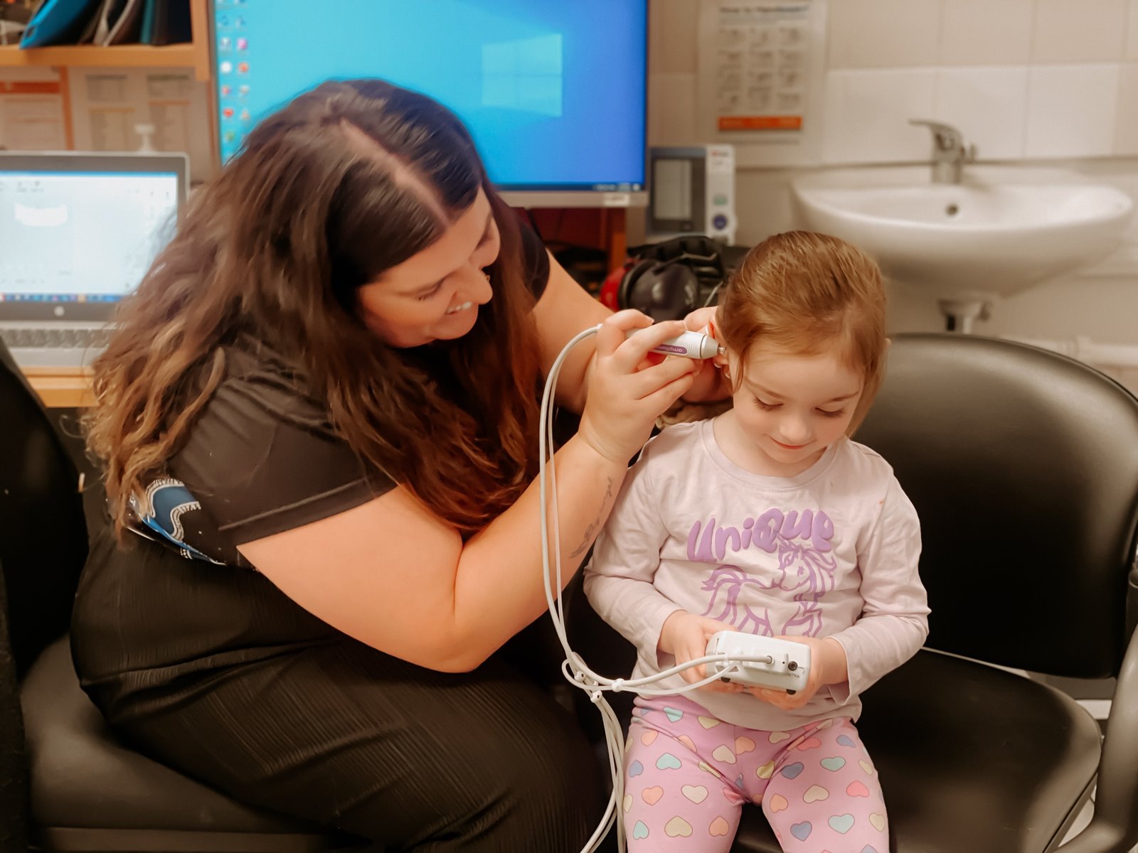 A Hearing Australia audiologist checking a child's hearing in a supportive and caring environment