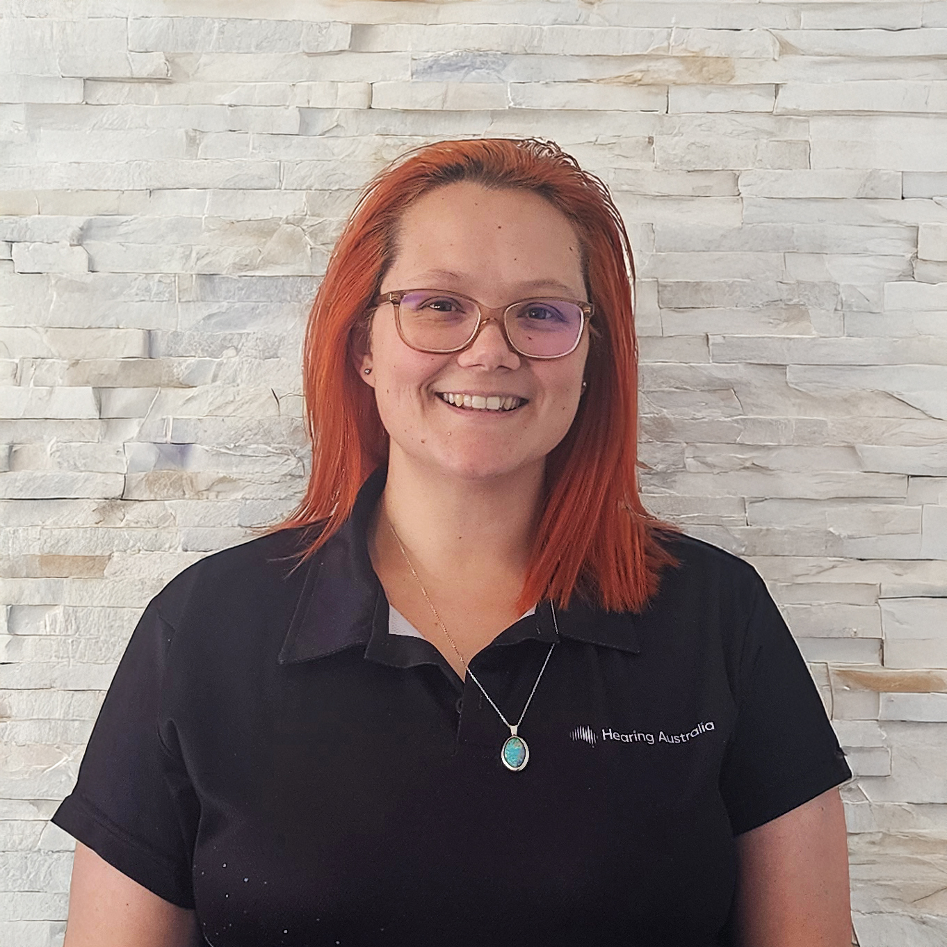 Tamarra, Clinical Community Advisor at Hearing Australia, smiling warmly